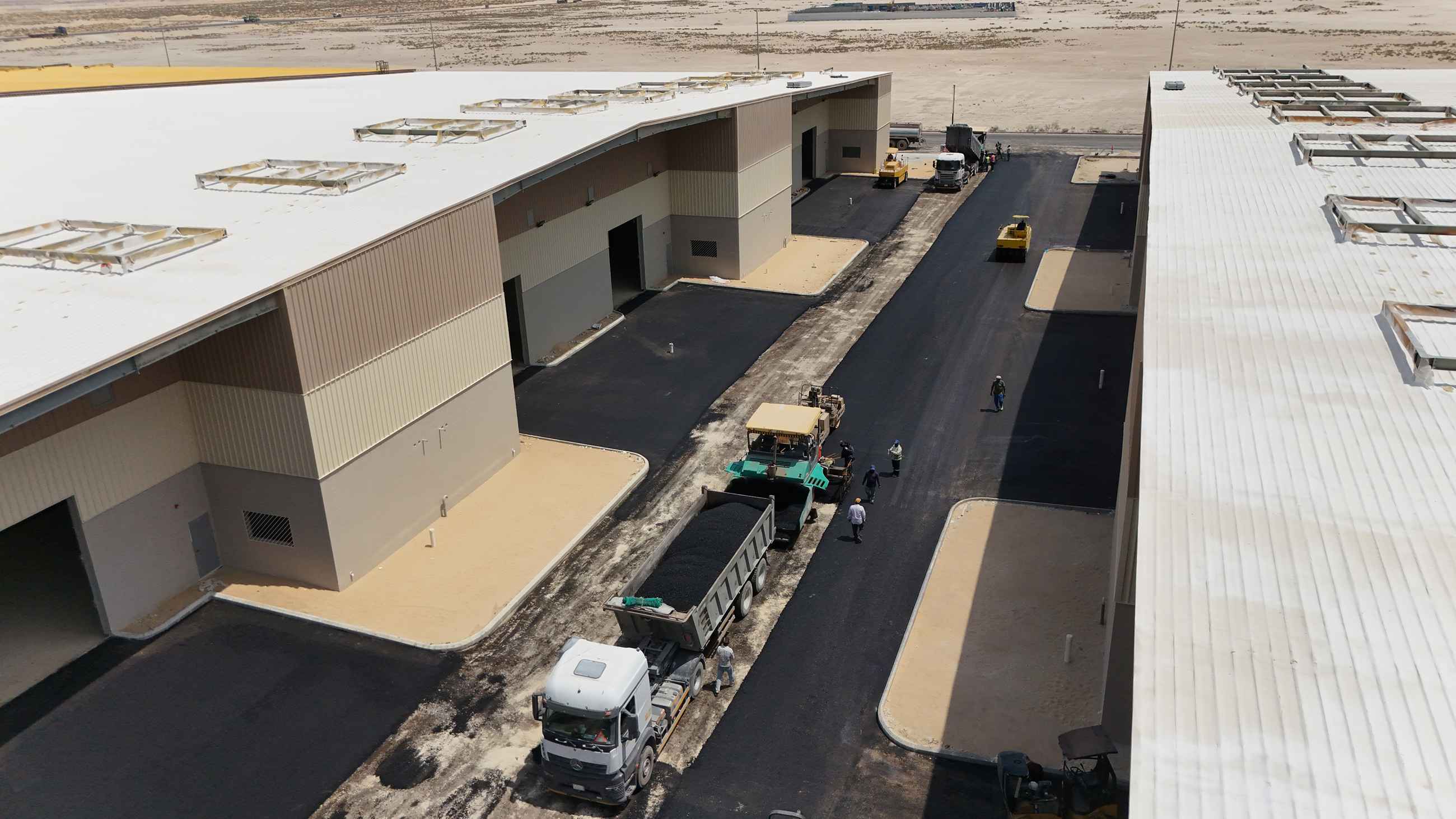 A practical guide to durable unpaved access roads in Saudi Arabia, covering soil tests, traffic loads, drainage, materials, compaction, maintenance, and polymer stabilization.